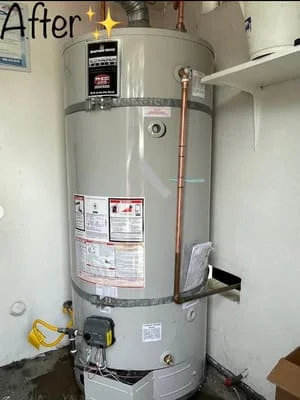 Newly installed gas water heater with copper piping and safety relief valve connections