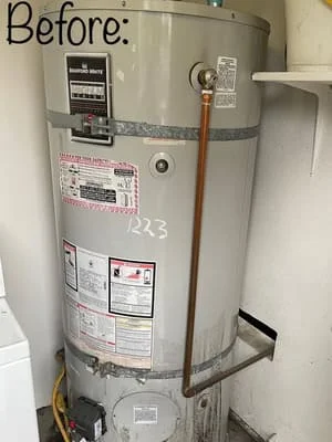 Before photo of old water heater with worn exterior and multiple warning labels